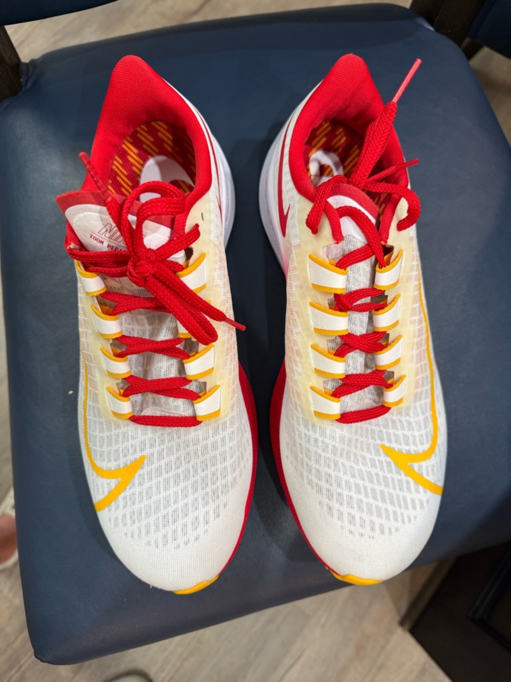 Nike White Running Shoes with Red & Yellow Accents